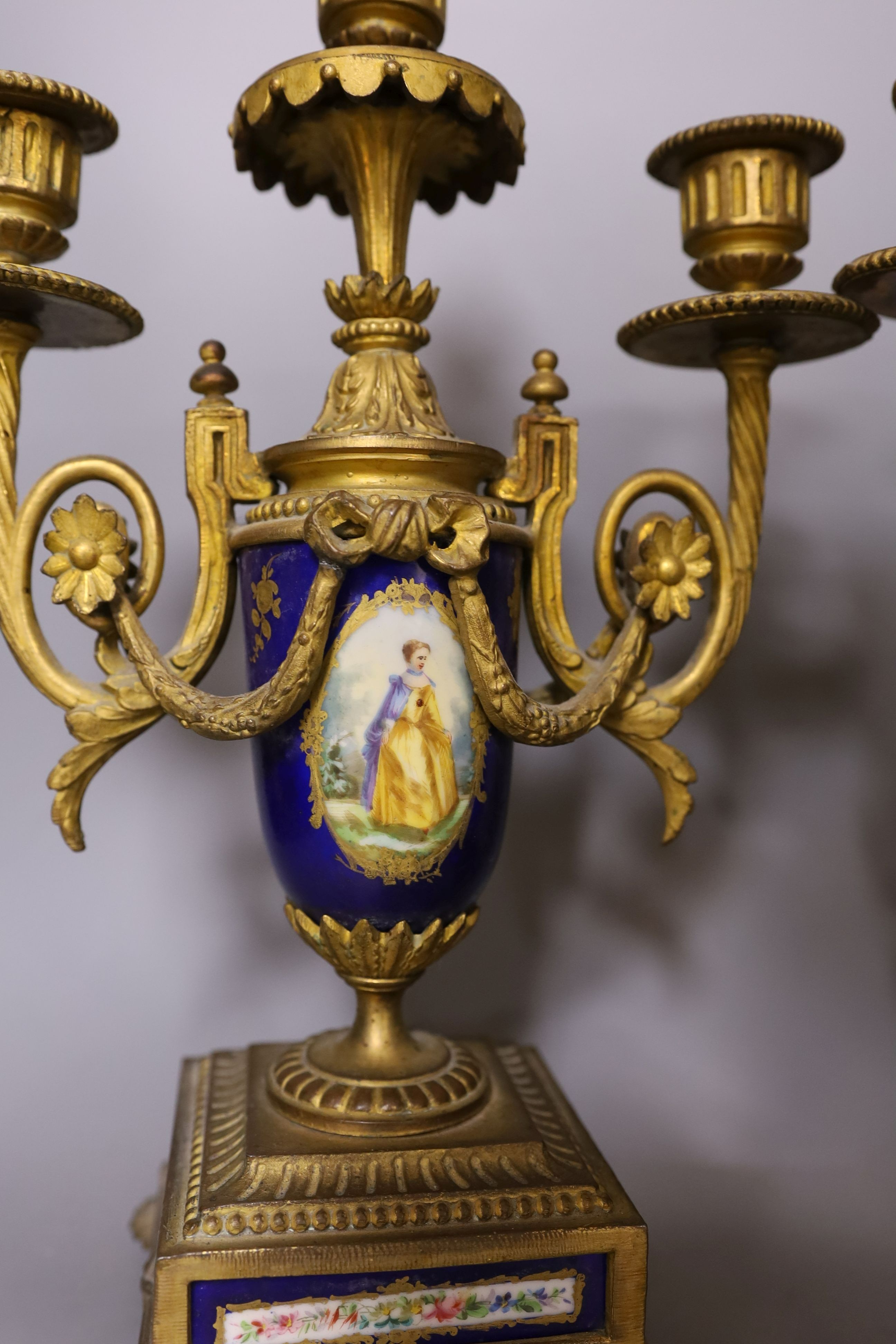 A pair of Sevres style porcelain and ormolu candelabra, 36 cms high.